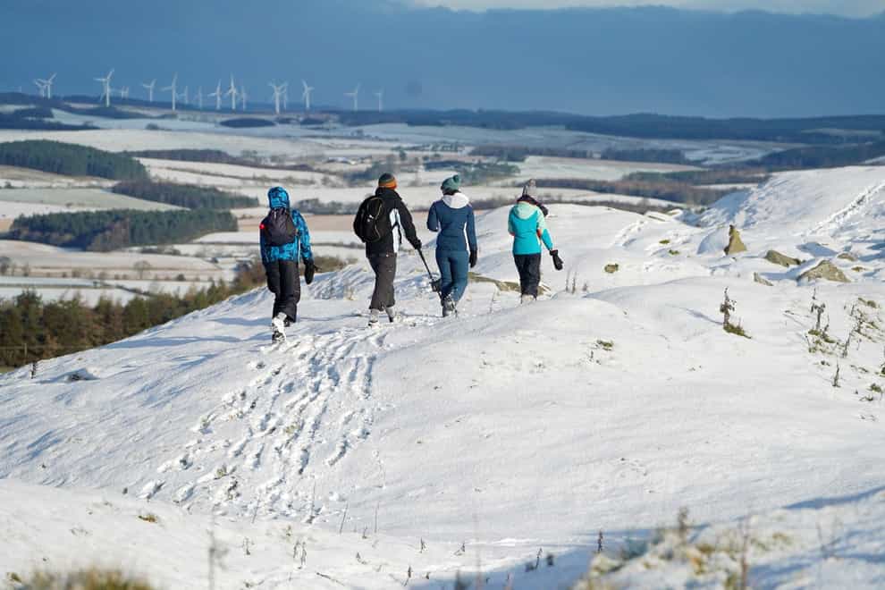 Hikers at Limestone Corner walk along a snow-covered Hadrian’s Wall near Hexham, Northumberland