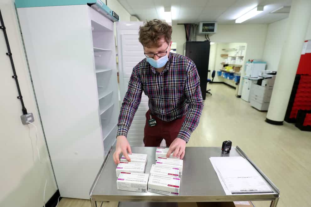Assistant technical officer Lukasz Najdrowski unpacks doses of the Oxford University/AstraZeneca Covid-19 vaccine as they arrive at the Princess Royal Hospital in Haywards Heath, West Sussex