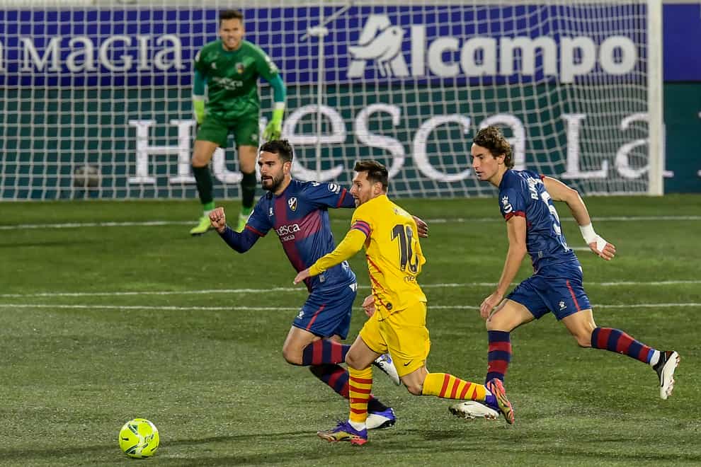 Lionel Messi (centre) set up Frenkie De Jong's goal in Barcelona's win at Huesca (Alvaro Barrientos/AP).