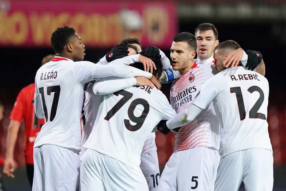 Milan’s Franck Kessie, centre, is mobbed by team-mates after converting his first-half penalty at Benevento