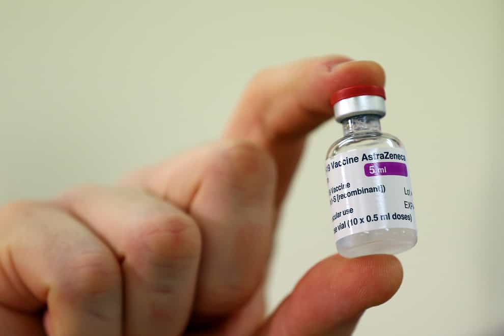 A vial of doses of the Oxford University/AstraZeneca Covid-19 vaccine is checked