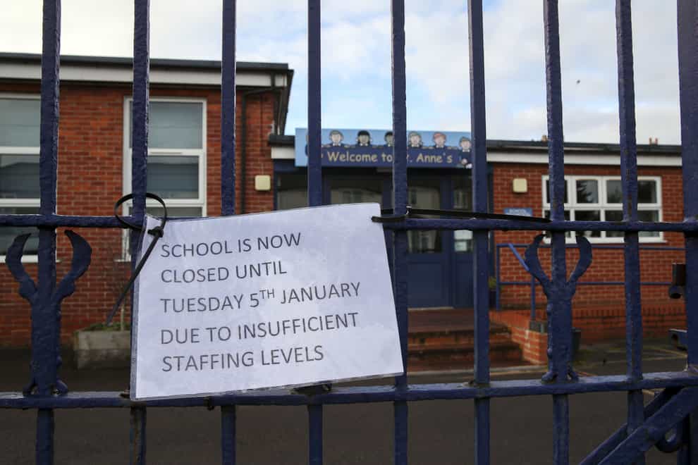 A sign hangs on the gate of St Anne’s Catholic Primary school in Caversham, Reading, informing parents that the school is closed due to insufficient staffing levels