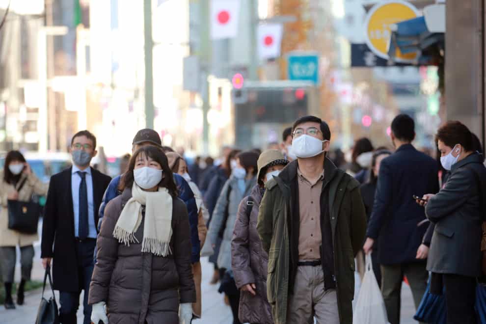 People wearing face masks to protect against the spread of the coronavirus walk at Ginza shopping street in Tokyo