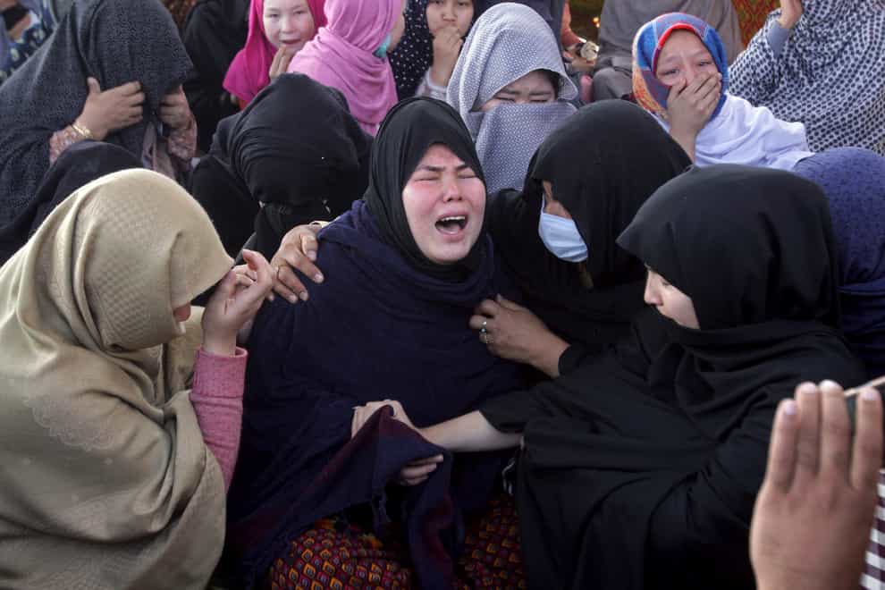 Women from the Shiite Hazara community mourn over death of their family members during a a sit-in protest against the killing of coal mine workers (Arshad Butt/AP)