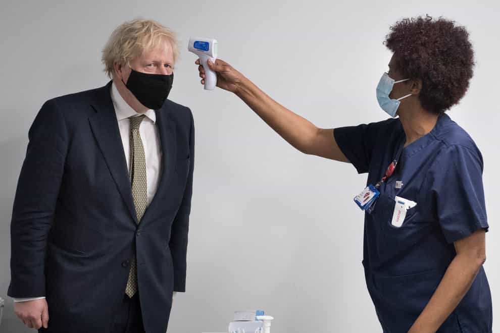 Prime Minister Boris Johnson has his temperature checked