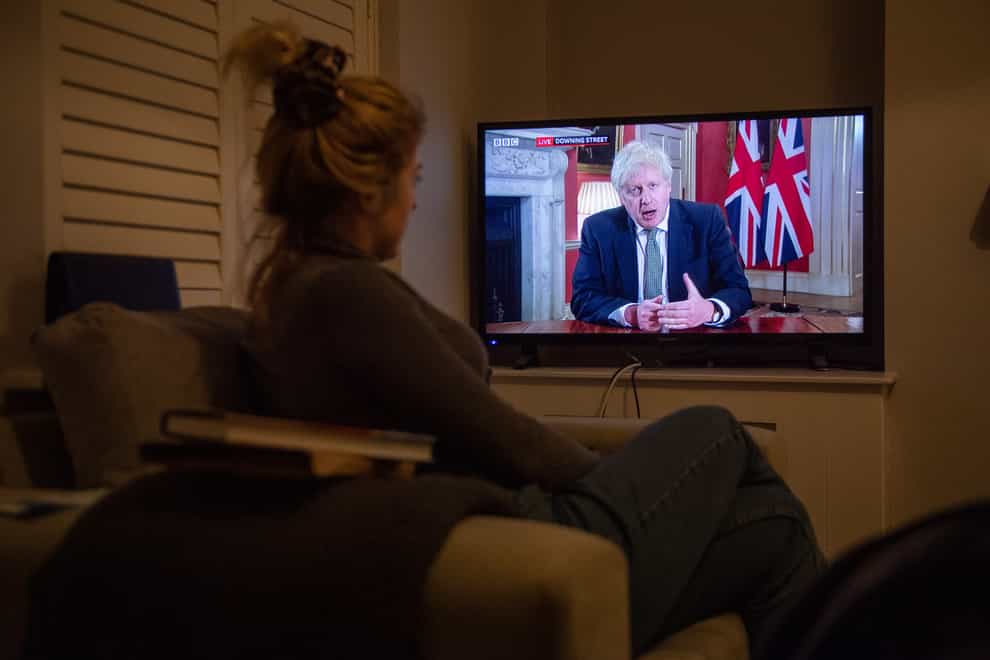 A woman watched Boris Johnson's televised announcement on new lockdown measures for England.