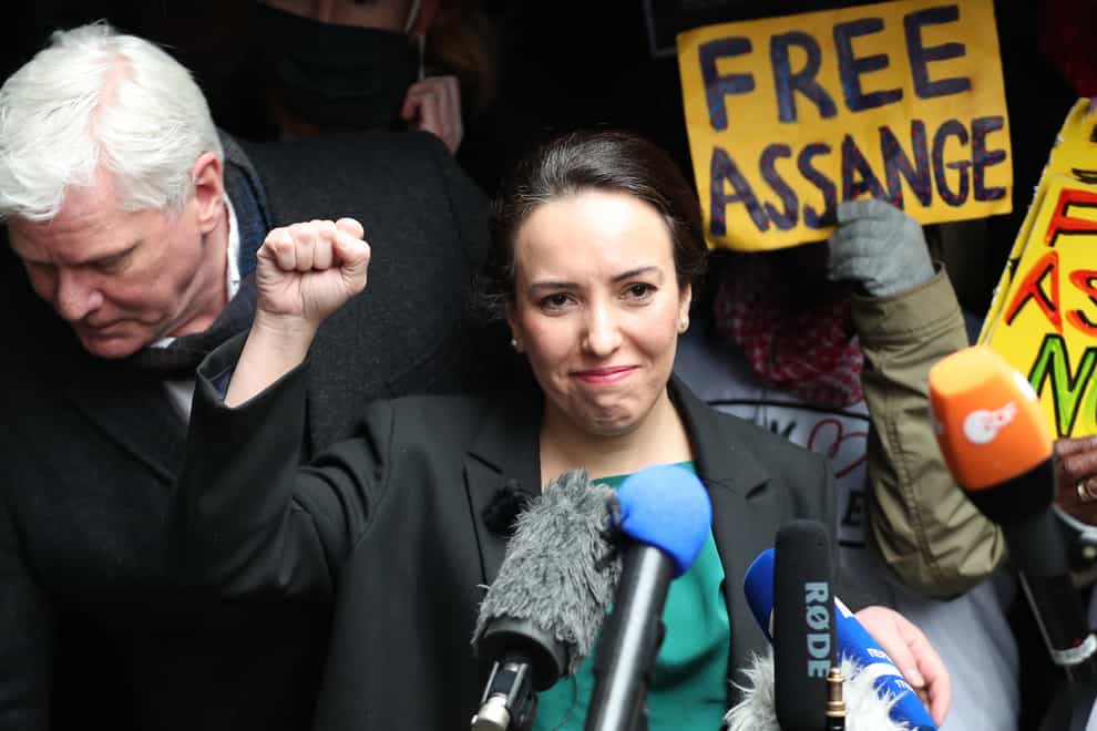 Wikileaks founder Julian Assange’s partner, Stella Moris, raises her fist as she speaks to the media