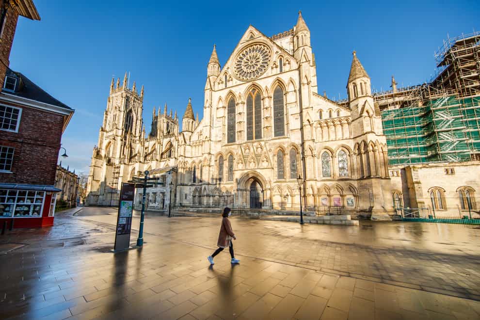 A woman walks past York Minster in Yorkshire the day after Prime Minister Boris Johnson ordered a new national lockdown for England