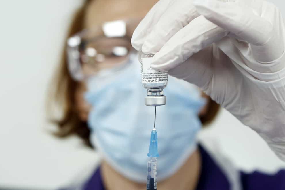 Nurse Pat Sugden prepares the Pfizer-BioNTech vaccine