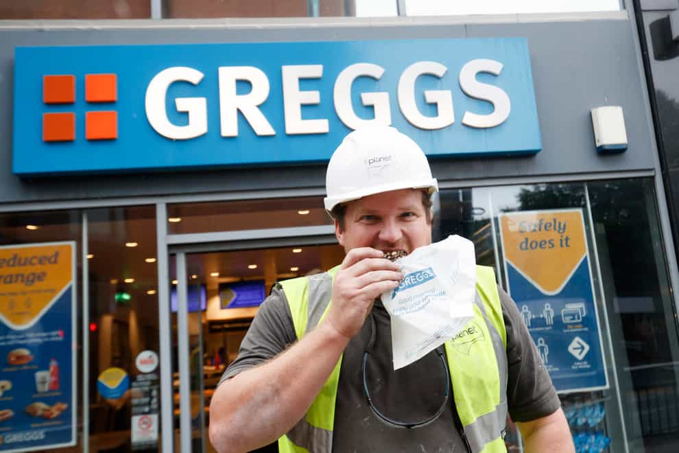 A man eating at Greggs