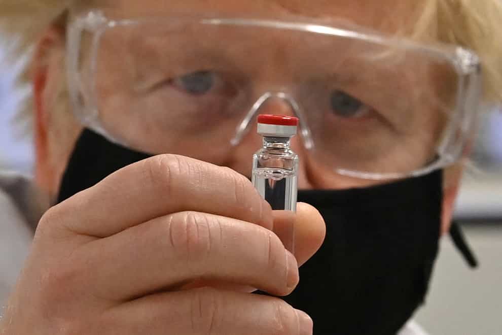 Prime Minister Boris Johnson holding a vial of the Oxford/AstraZeneca Covid-19 candidate vaccine