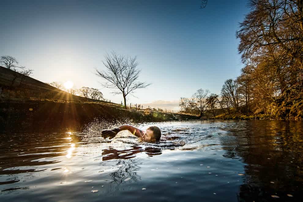 Les Peebles swims in the River Ribble near Stainforth in North Yorkshire
