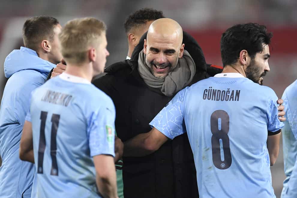 Pep Guardiola celebrates the win with his players