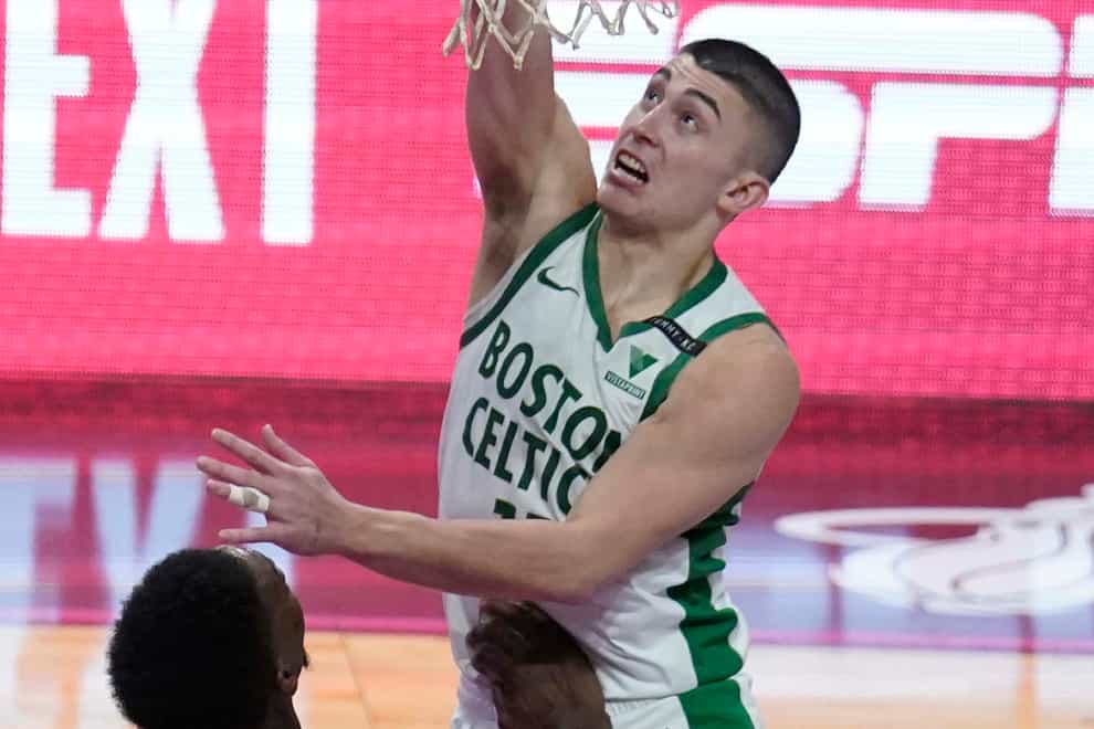Boston Celtics guard Payton Pritchard (11) scores the game winning basket during the second half of an NBA basketball game against the Miami Heat