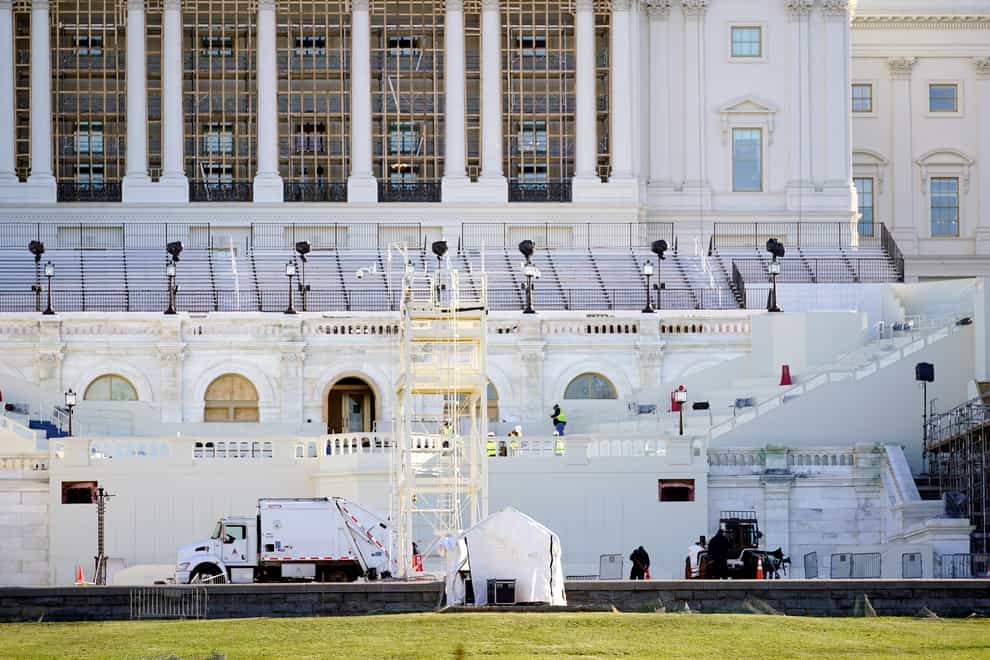 Maintenance workers cleaning outside a mostly quiet Capitol on Thursday morning (Julio Cortez/AP)