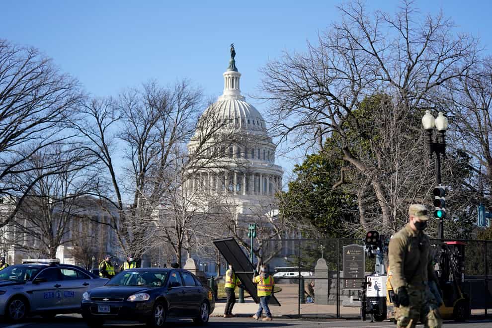 Workers install no-scale fencing around the US Capitol in Washington