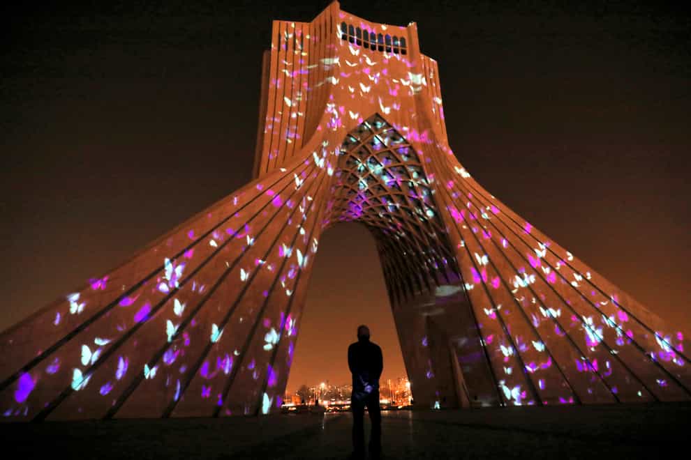 The video mapping is projected on Tehran’s Azadi (freedom) tower to commemorate 176 victims of the Ukrainian flight during a municipal memorial marking the first anniversary (Ebrahim Noroozi/AP)