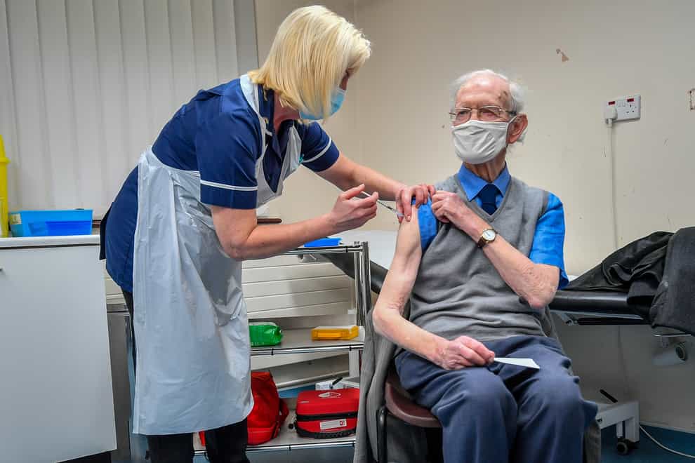 Ralph Evans, 88, receives the Oxford University/AstraZeneca COVID-19 vaccine at Pontcae Medical Practice in Merthyr Tydfil