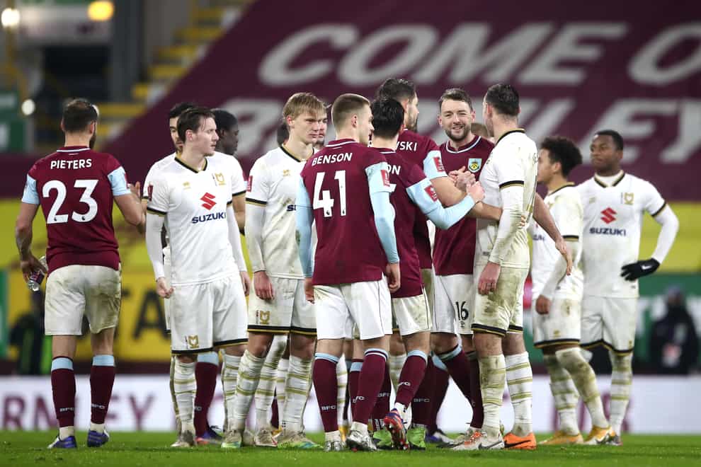 Burnley and MK Dons players shake hands following the Clarets' shoot-out victory