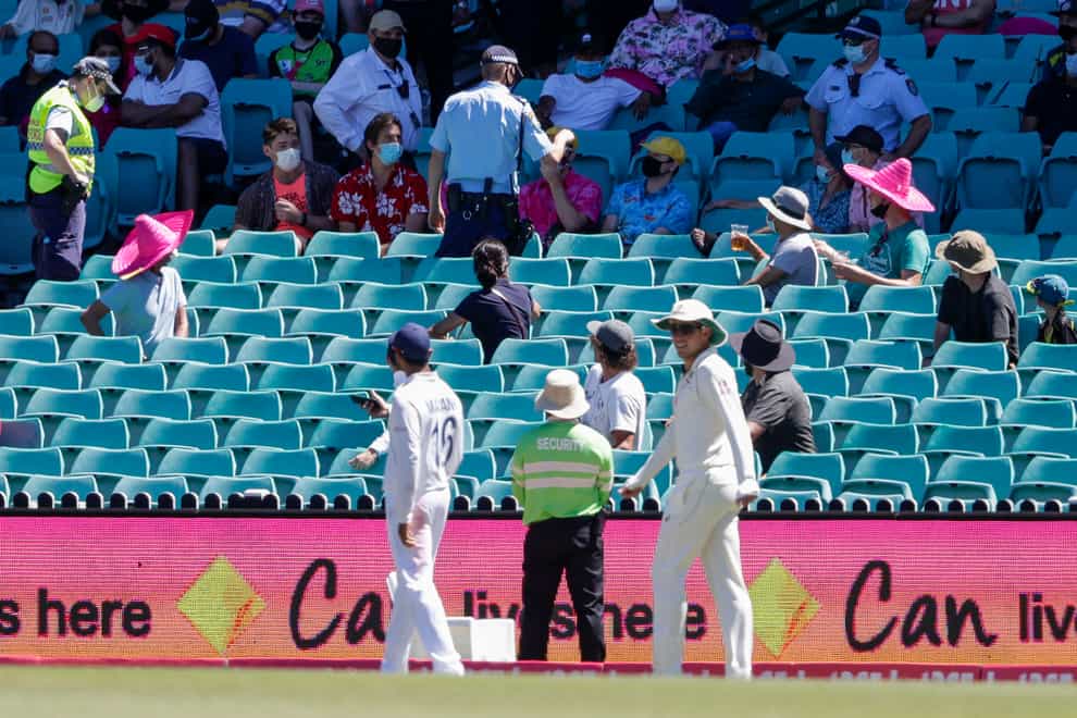 Police, top, remove spectators from the game during play on day four of the third Test between India and Australia at the SCG