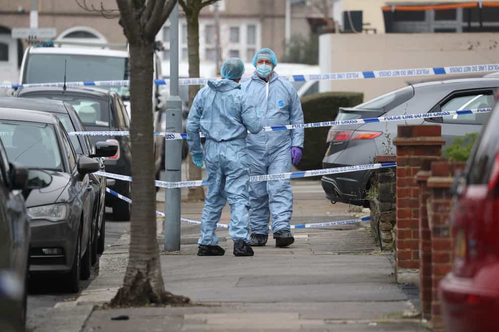 Forensic officers in Tavistock Gardens, Ilford, where two men died on Sunday