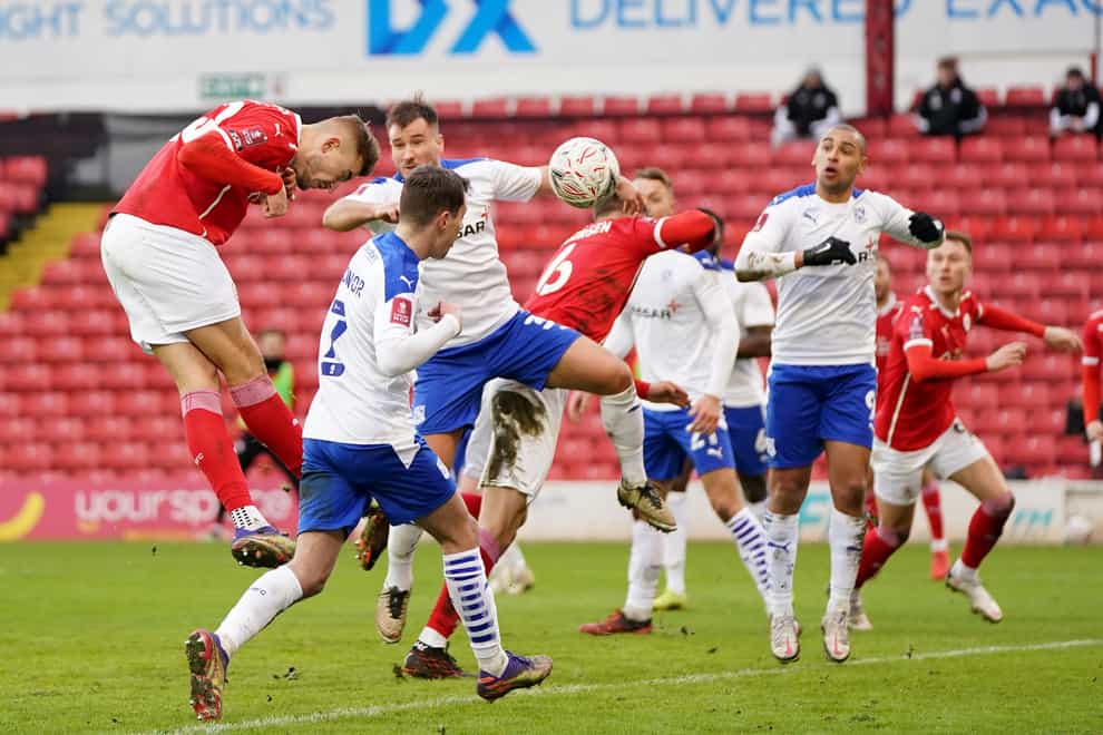 Barnsley’s Michal Helik (left) heads home his side's opener in a 2-0 FA Cup third round win over Tranmere.