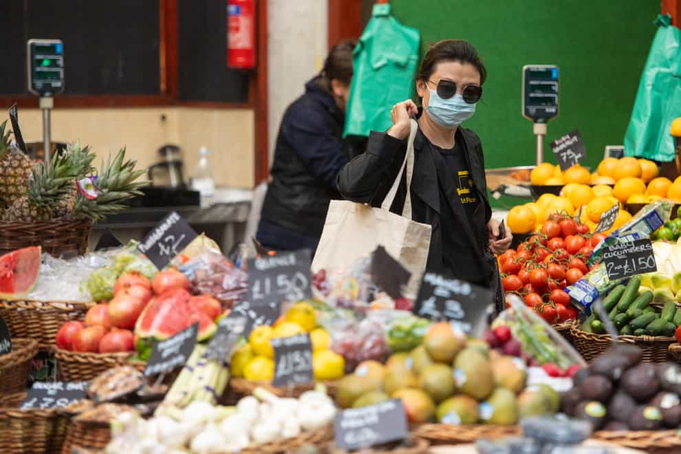 A shopper wearing a protective face mask at Borough Market in London in June 2020