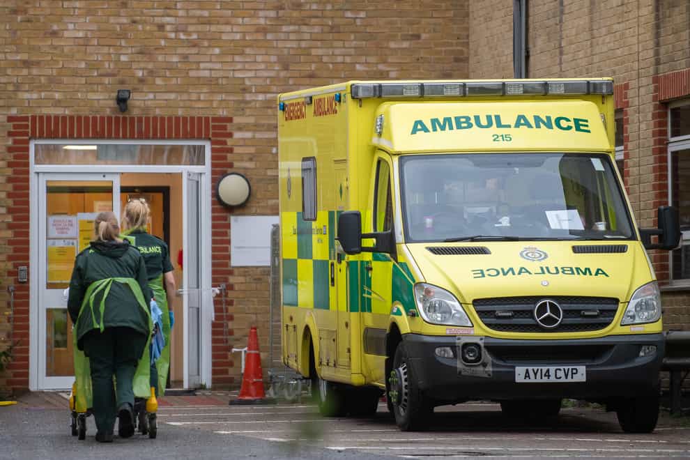 Paramedics transfer a patient from an ambulance into Southend University Hospital in Essex