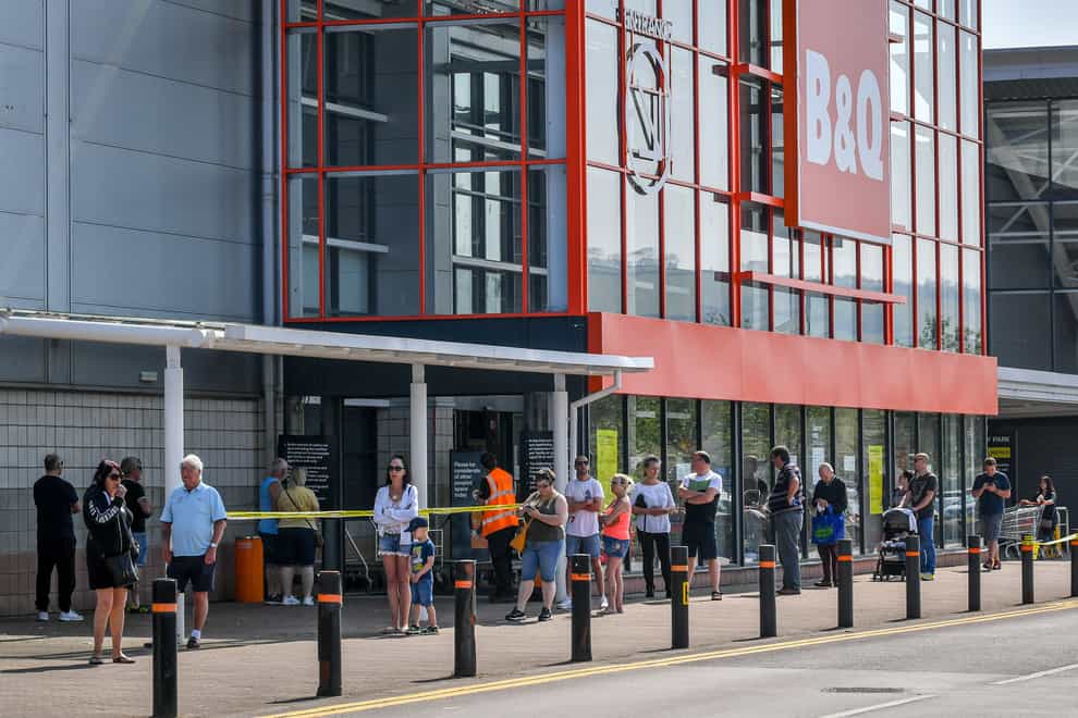 Customers queue outside a B&Q store