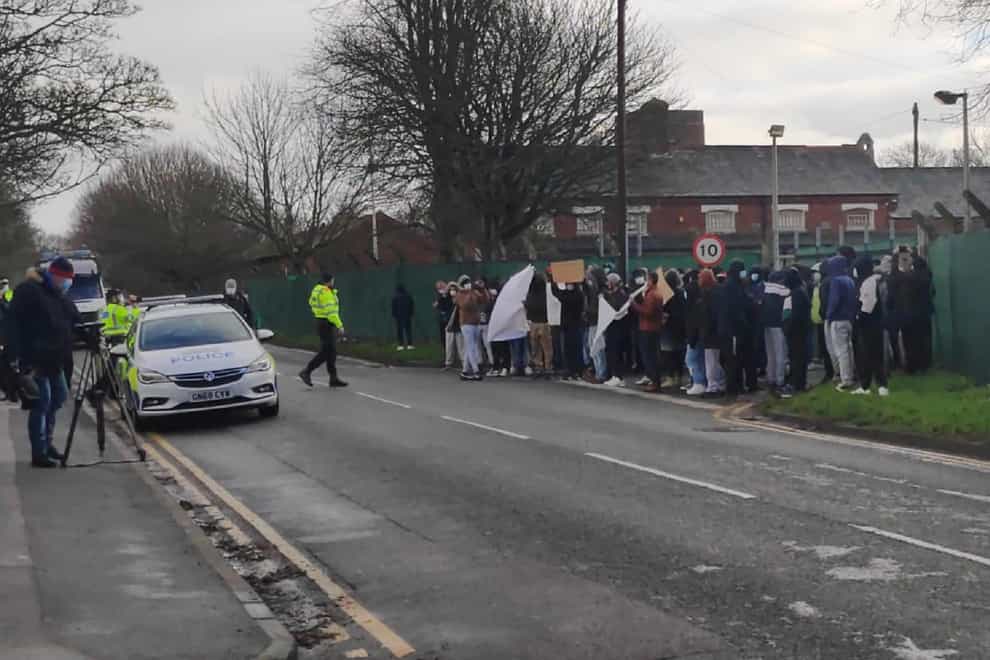Asylum seekers protesting outside Napier Barracks in Folkestone