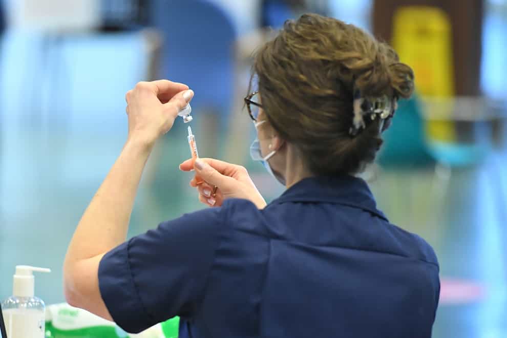 A member of staff prepares a vaccine