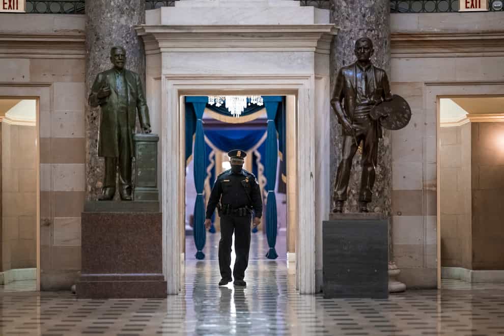 A US Capitol Police officer patrols the area near the House of Representatives chamber (J. Scott Applewhite/AP)