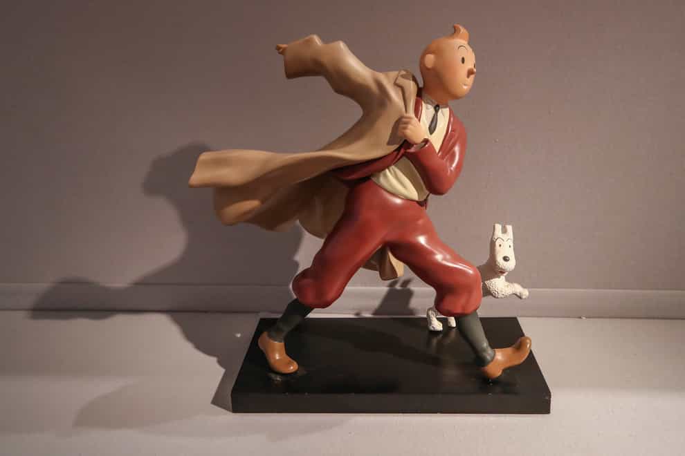 A 1988 polychrome resin sculpture of the comic character Tintin and his dog Snowy (Michel Euler/AP)