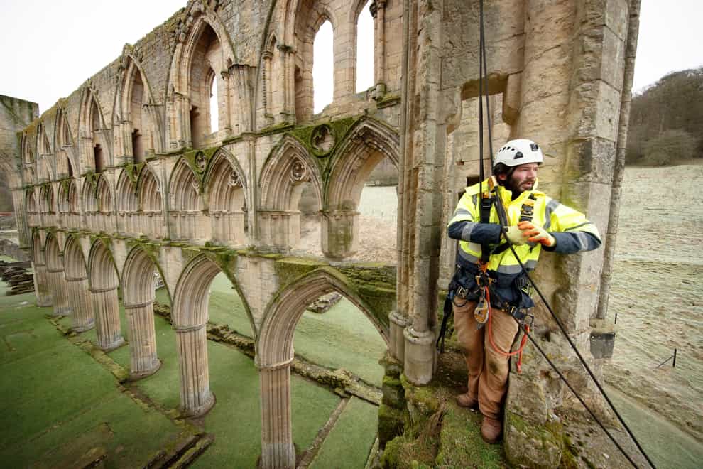 Stonemason James Preston from SSH Conservation surveys Rievaulx Abbey in North Yorkshire