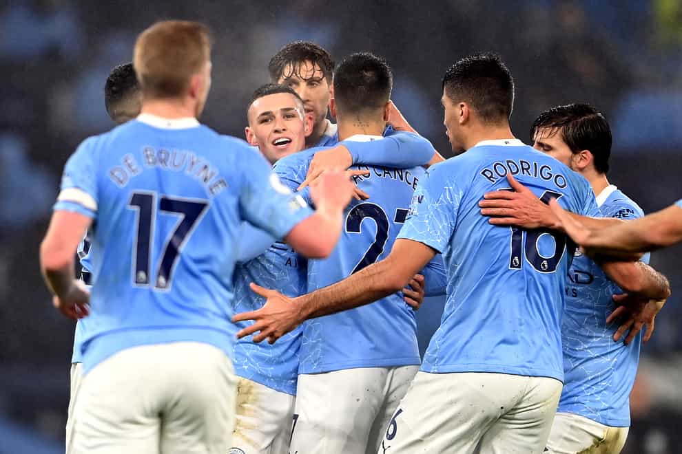 Manchester City players celebrate Phil Foden's goal against Brighton on Wednesday night, despite warnings for players to avoid hugging