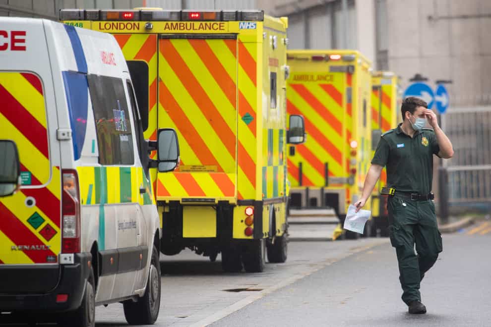 A paramedic walks past a line of ambulances outside the Royal London Hospital