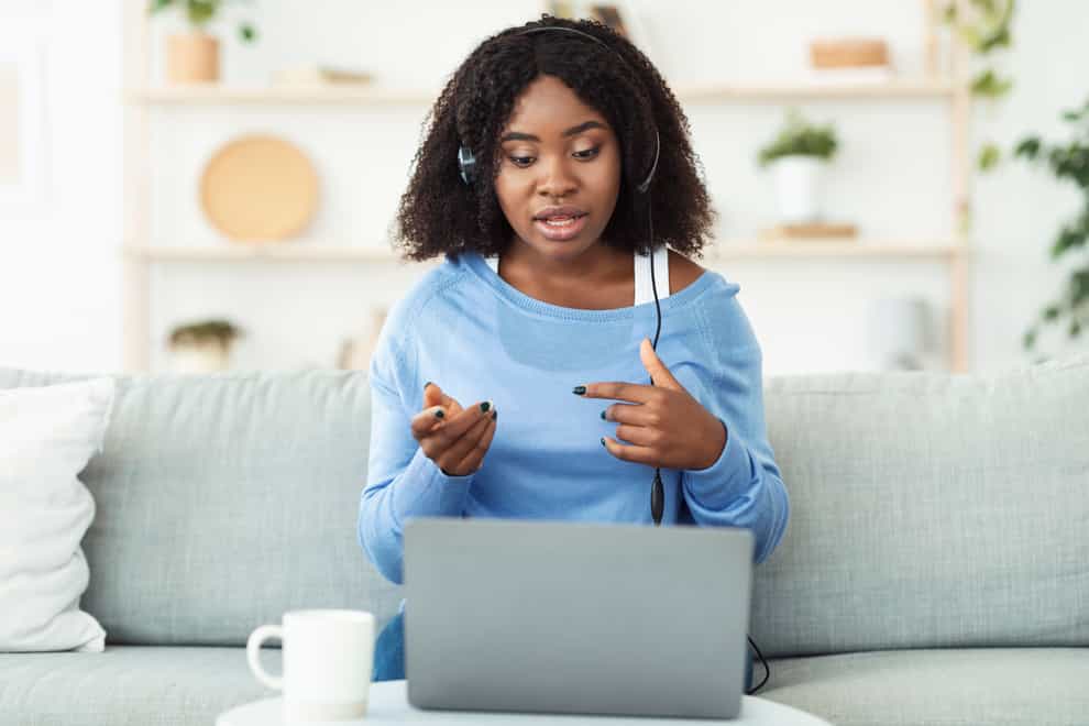 Black lady making video call at home on laptop