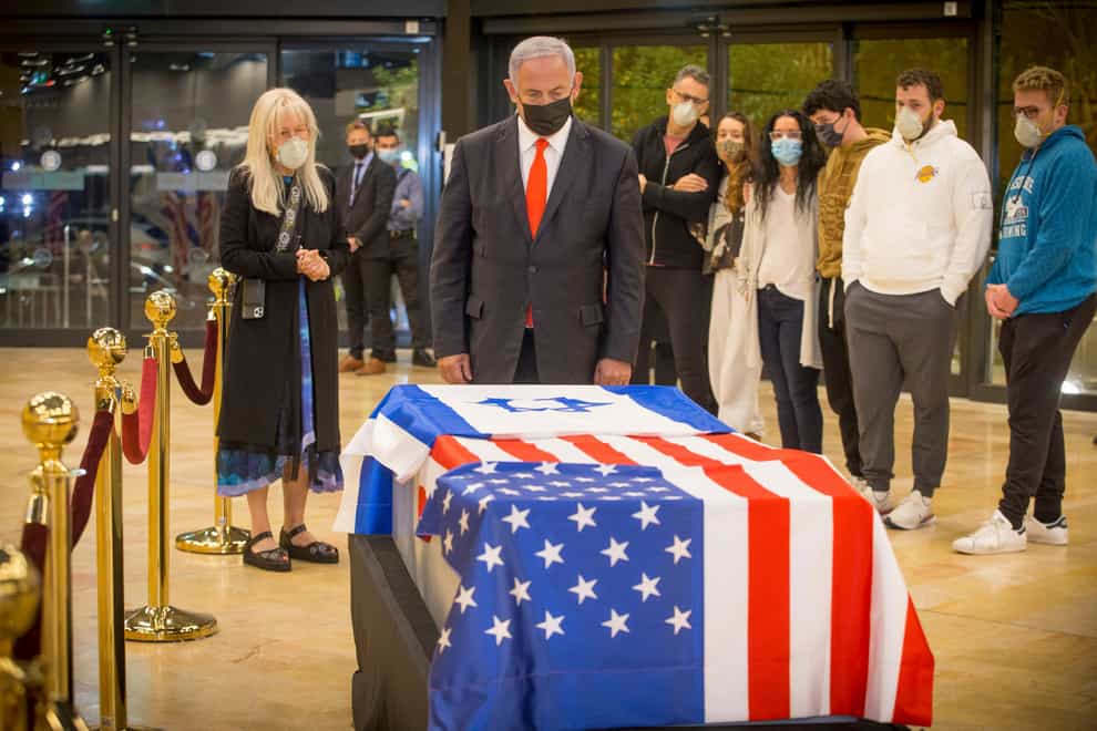 Israeli prime minister Benjamin Netanyahu stands before the coffin of Sheldon Adelson (Ami Shooman/AP)