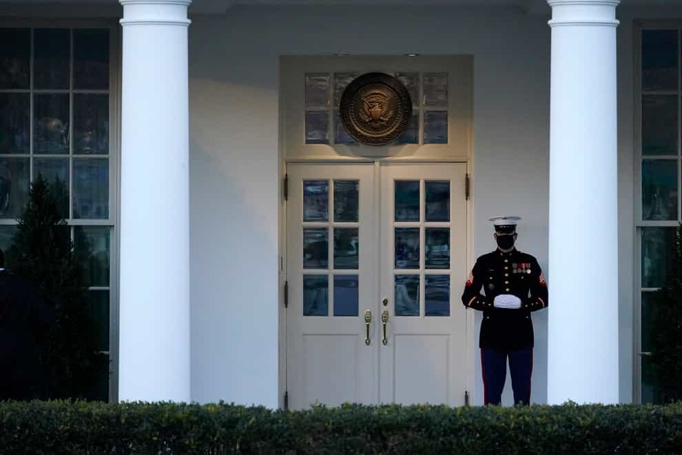 A Marine guard stands at the entrance to the West Wing of the White House (Gerald Herbert/AP)