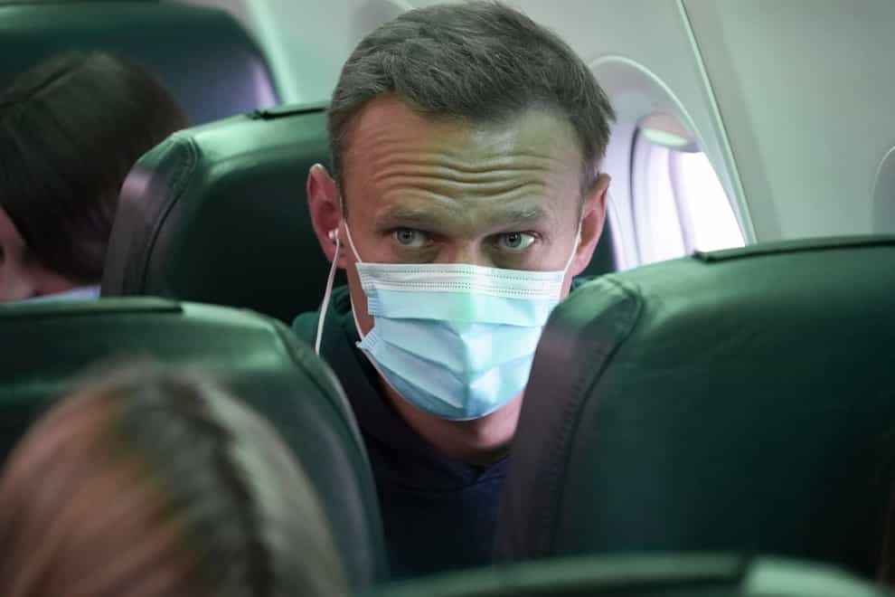 Alexei Navalny sits on the plane prior to a flight to Moscow