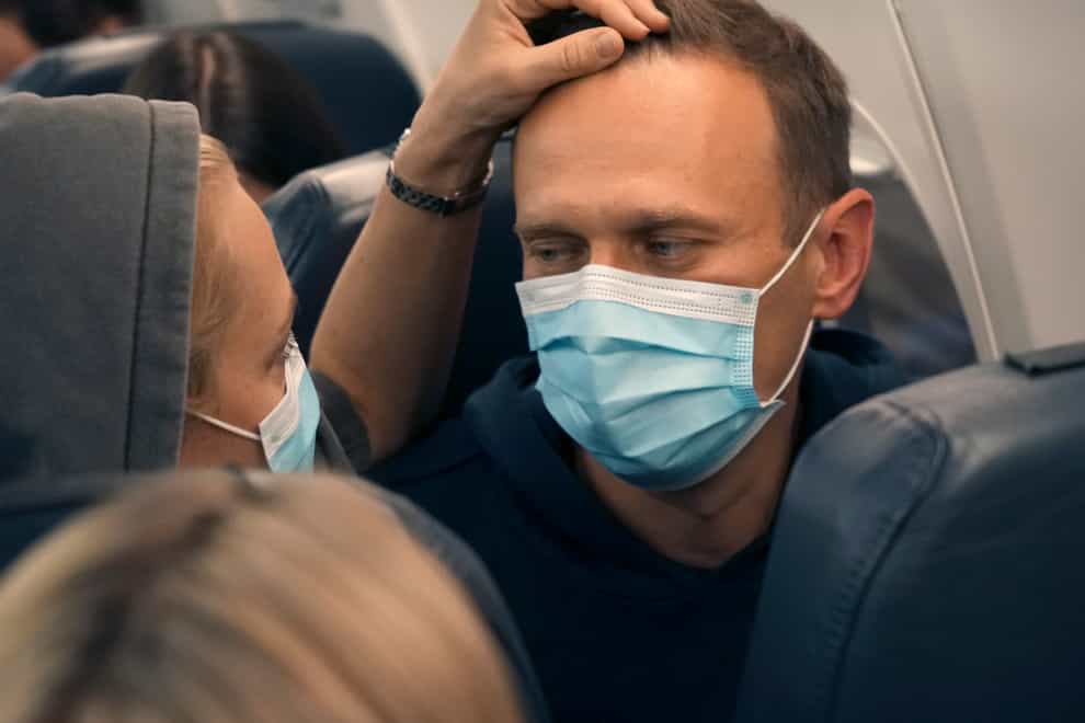 Alexei Navalny and his wife Yulia sit on the plane on a flight to Moscow