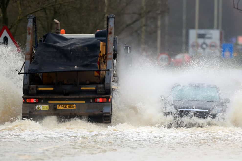 Vehicles negotiate a flooded road in Mountsorrel, Leciestershire