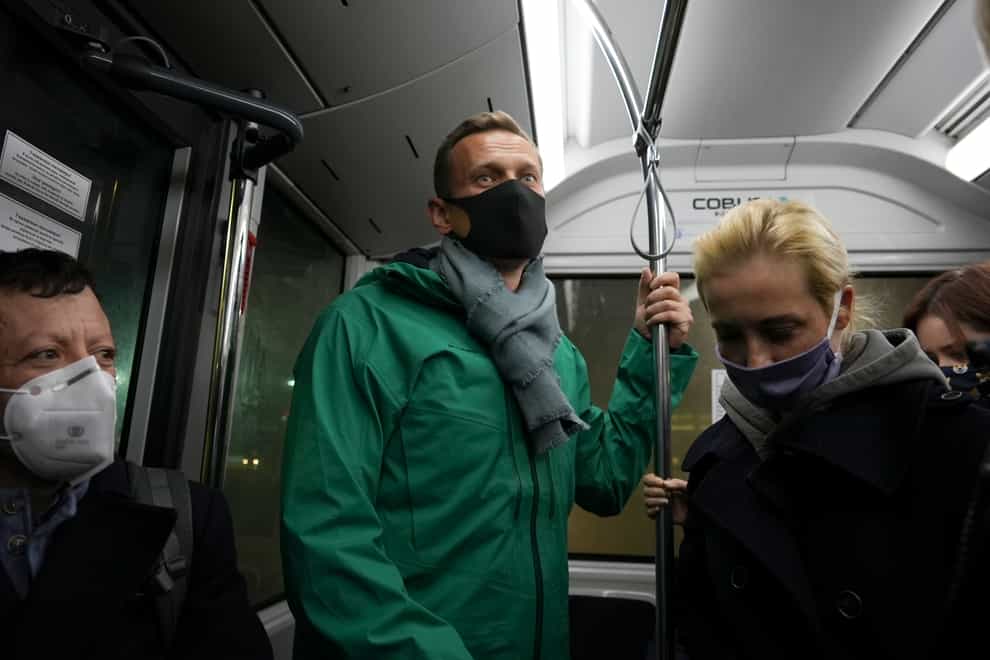 Alexei Navalny, centre, and his wife Yulia travel in an airport bus (Mstyslav Chernov/AP)