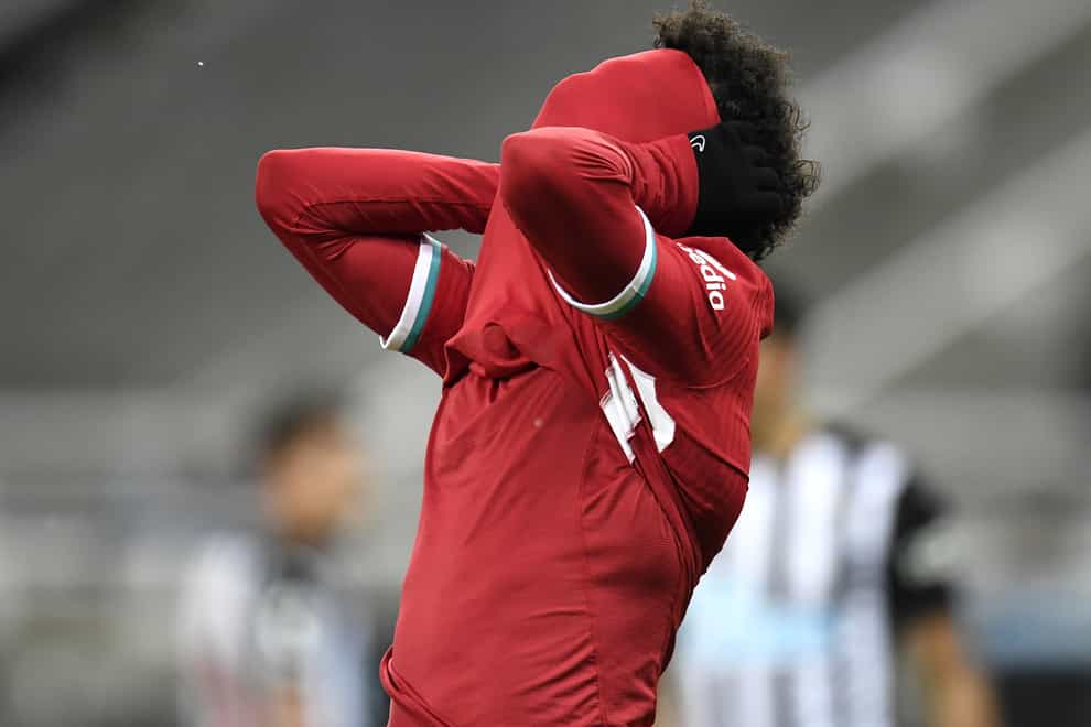Liverpool forward Mohamed Salah covers his face with his shirt