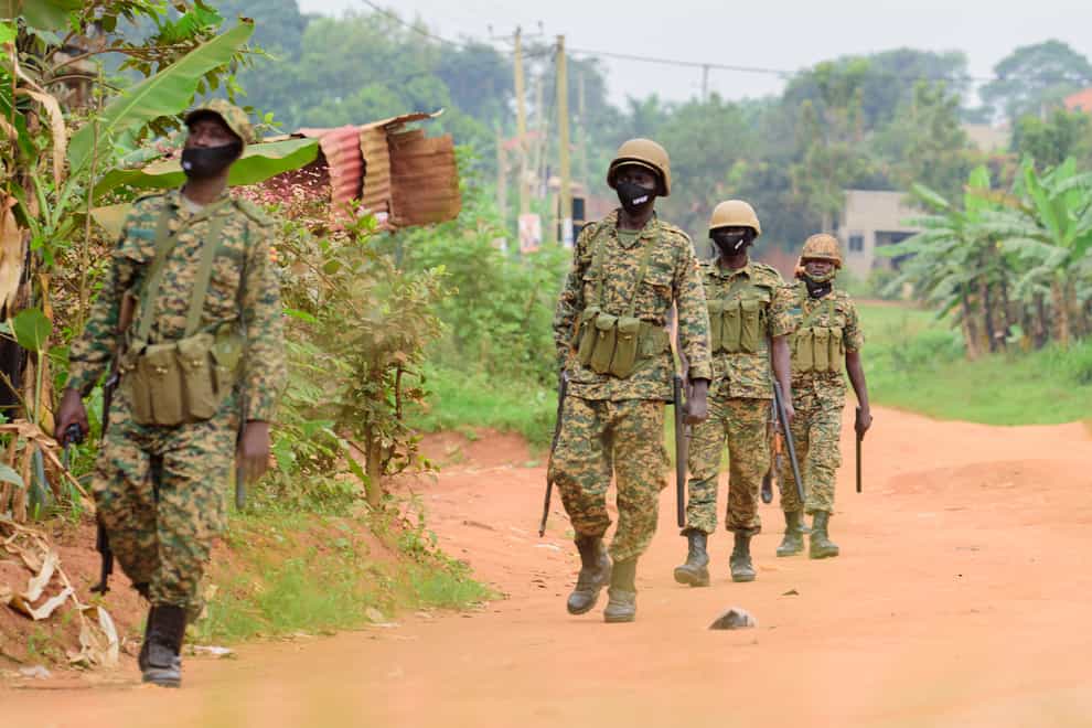 Soldiers patrol outside opposition challenger Bobi Wine’s home(Nicholas Bamulanzeki/AP)