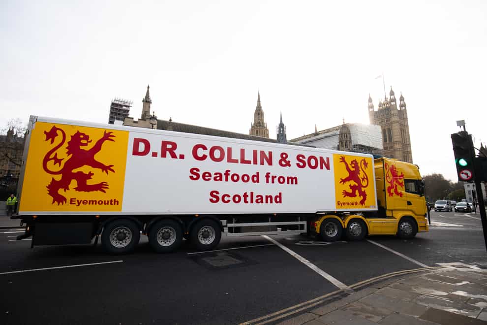 A lorry from DR Collin & Son passes in front of the Houses of Parliament