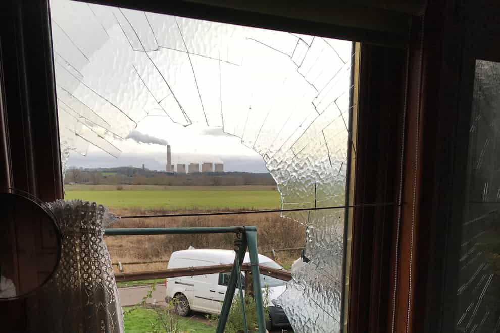 A smashed bathroom window shattered by a swan