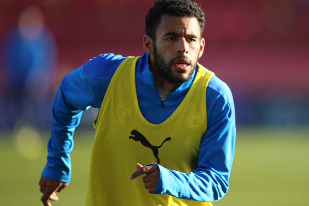 Peterborough defender Nathan Thompson warms up on the pitch