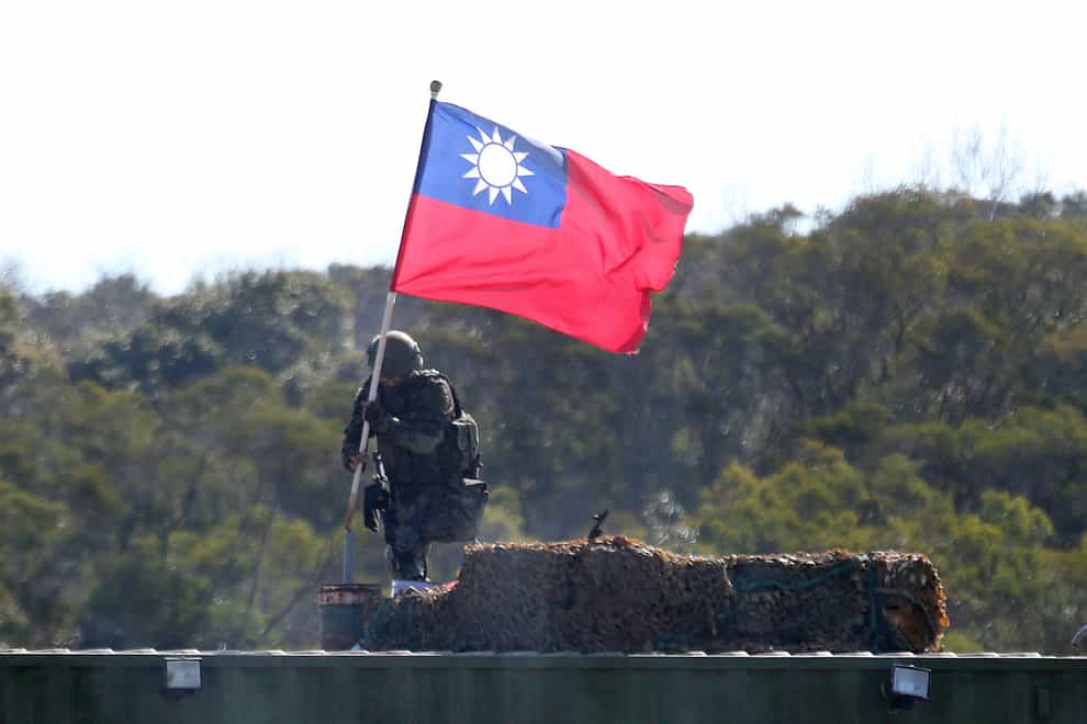A soldier holds a Taiwan national flag during a military exercise in Hsinchu County, northern Taiwan (Chiang Ying-ying/AP)