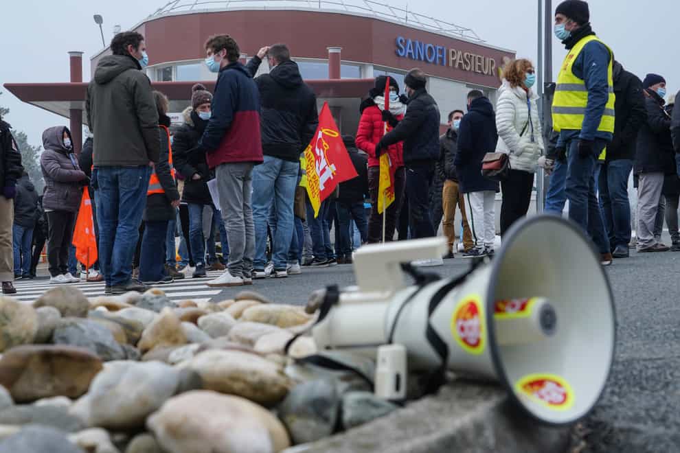 Striking workers gather outside the French pharmaceutical company Sanofi headquarters in Marcy l'Etoile